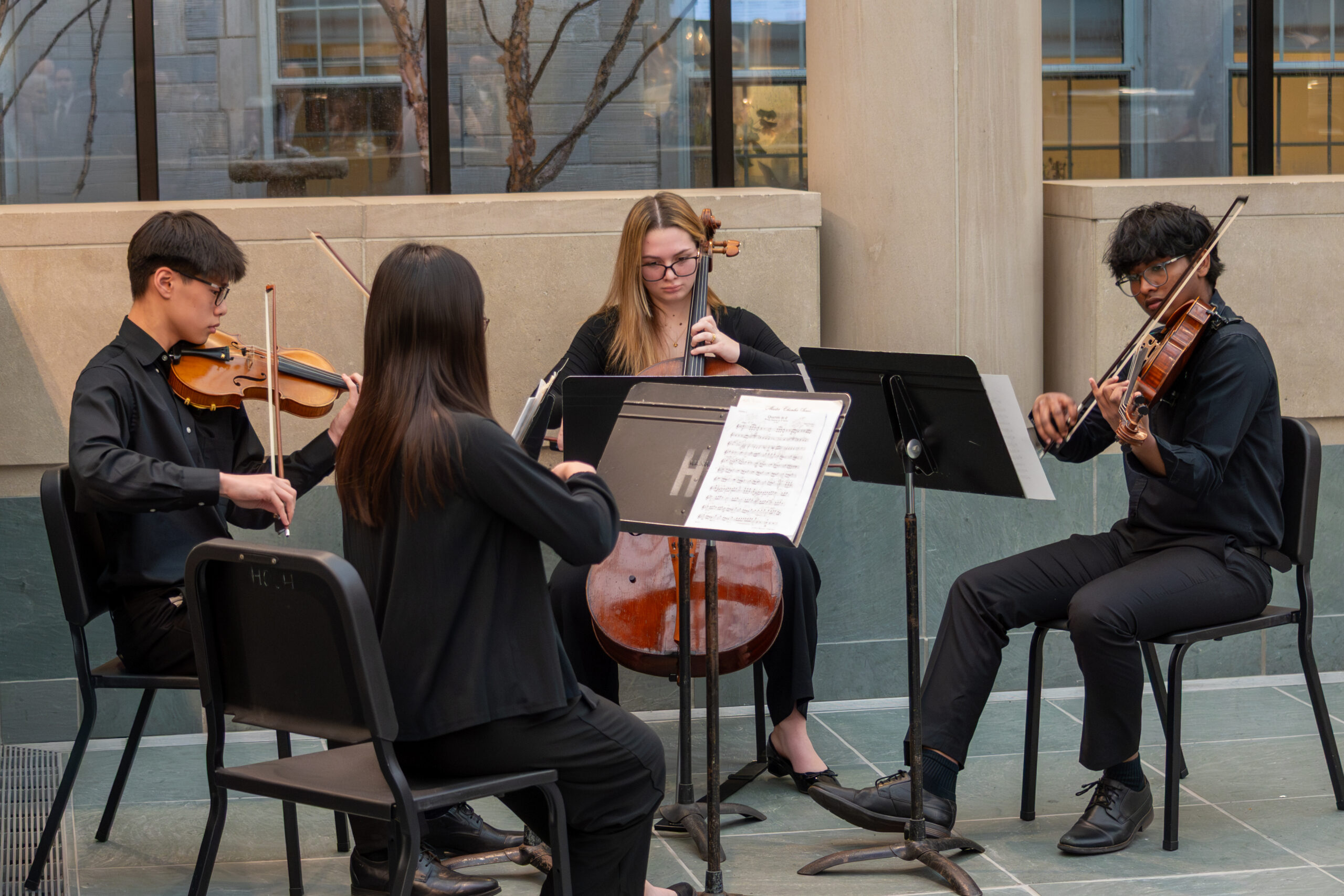 quartet playing together outside